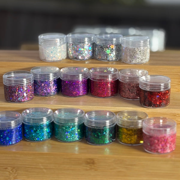 Assorted glitter jars on a wooden surface