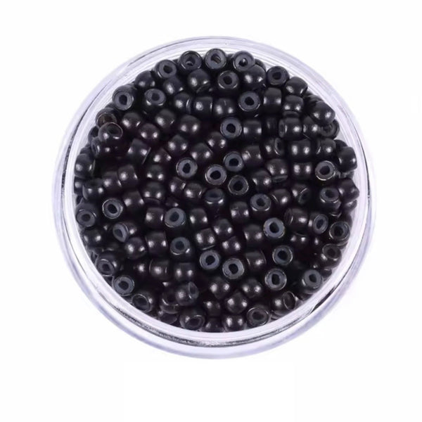 Clear container filled with 3mm black hair beads on a white background