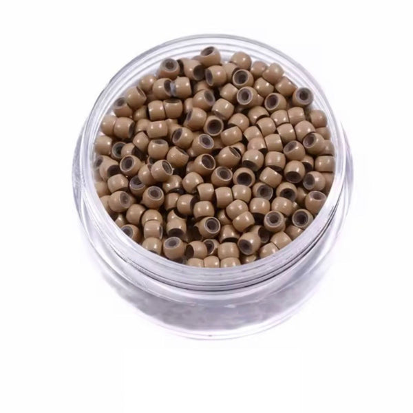 Clear container filled with small dark blonde beads on a white background