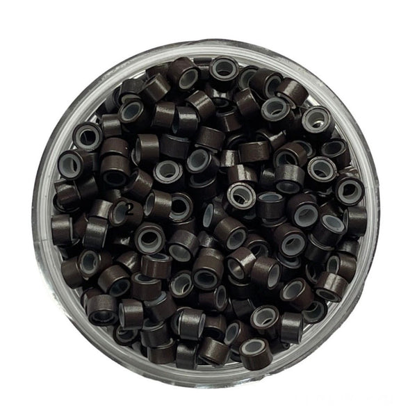 Clear container filled with black hair ties on a white background