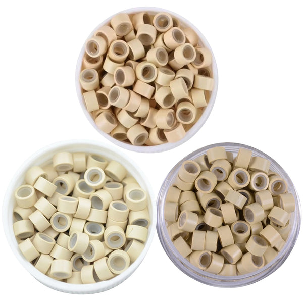 Three containers filled with 5mm size hair extension beads in colours blonde , light blonde, and beige on a white background