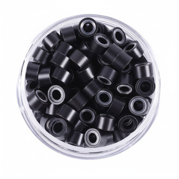 Clear container filled with black hair ties on a white background