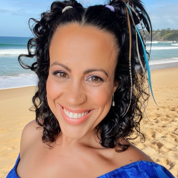 Woman with styled hair and a blue top indoors