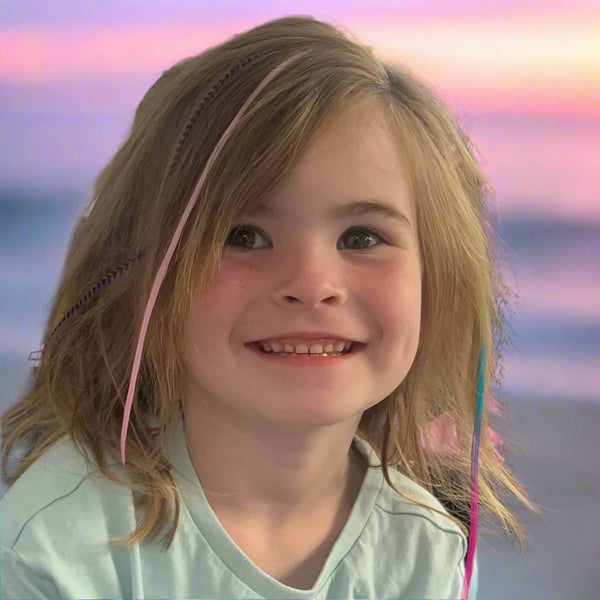 Young girl with braided hair smiling at the camera