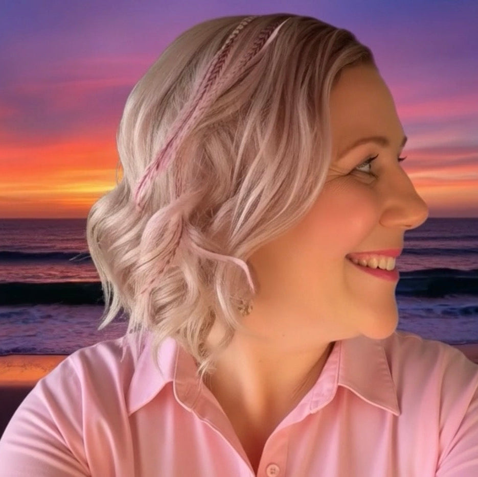 Woman with styled hair against a sunset beach backdrop