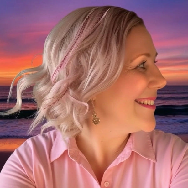 Woman with styled hair against a sunset beach background