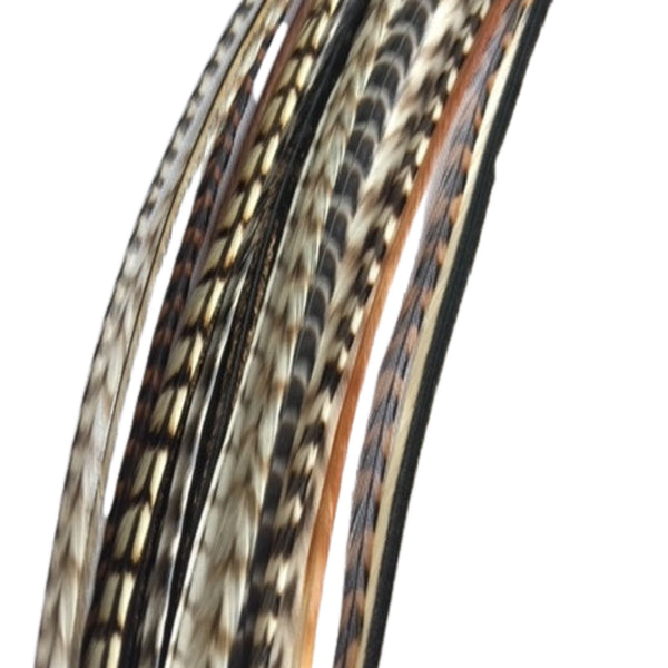 Close-up of bunch of natural hair feathers with grizzly pattern on a white background