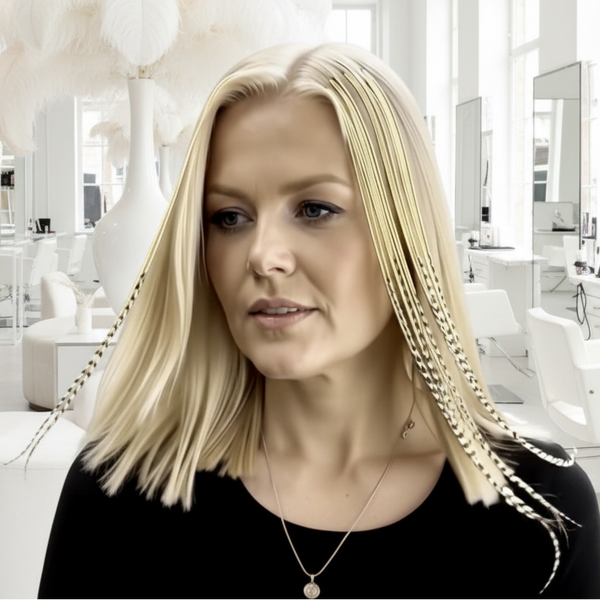 Woman with blonde hair and gold chains, wearing a black top.