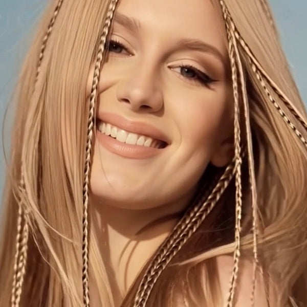 Close-up of a woman with blonde hair and a blue background
