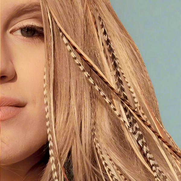 Close-up of a woman with Blonde Mix hair feathers against a blurred natural background