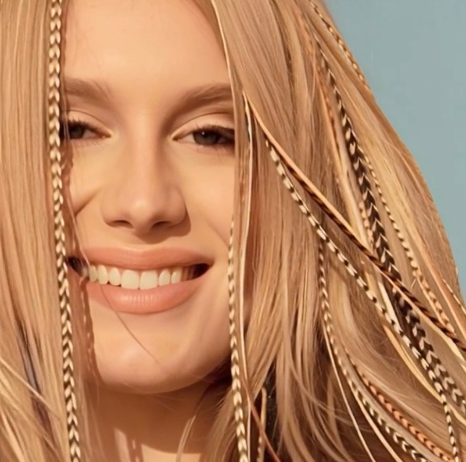 Close-up of a woman with blonde hair and a blue background