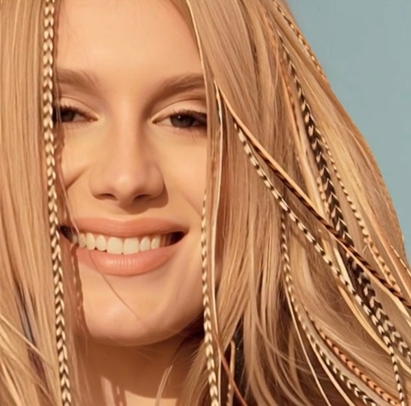 Close-up of a woman with blonde hair and a blue background