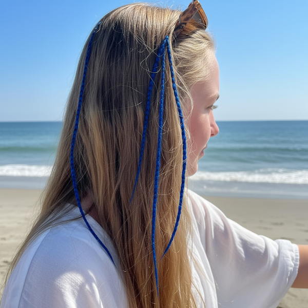 Woman with blue hair extensions standing on a beach