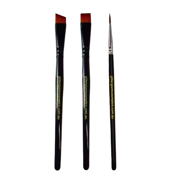 Three makeup brushes with black handles and red bristle tips on a white background.