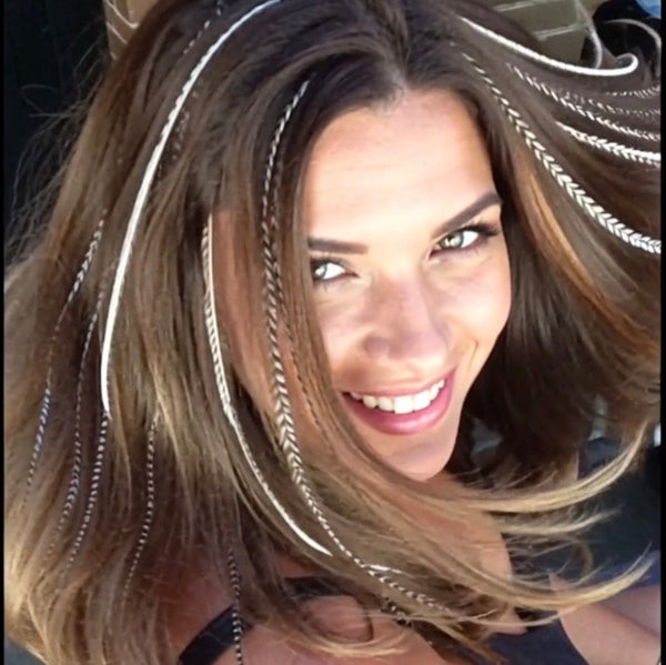Woman with long, wavy hair posing playfully, with Naturals Hair Feathers
