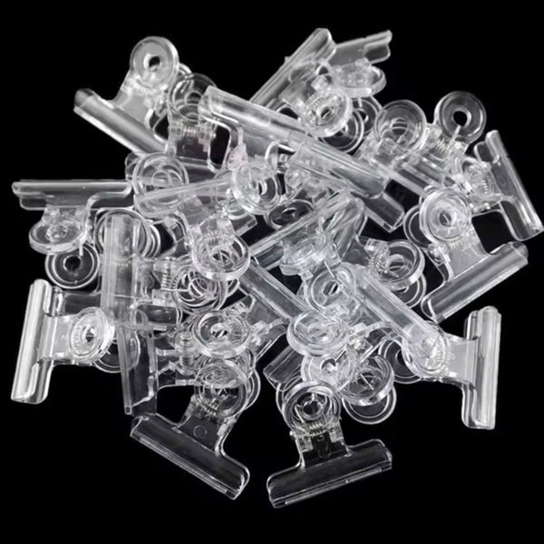 Clear plastic clips on a black background