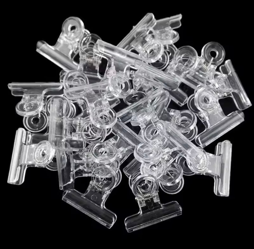 Clear plastic clips on a black background
