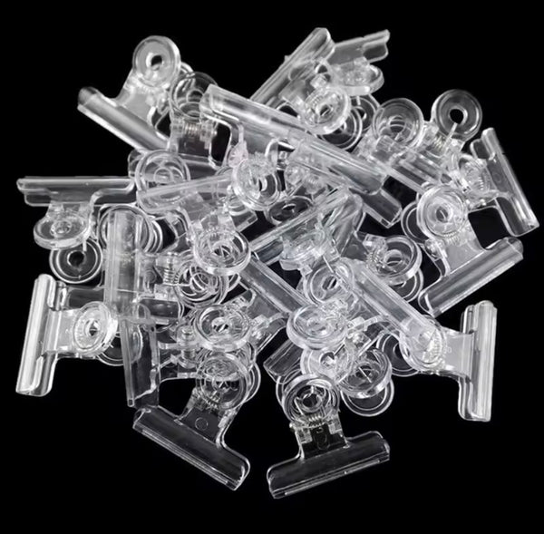 Clear plastic clips on a black background