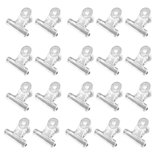 Multiple clear clips arranged in a grid on a white background