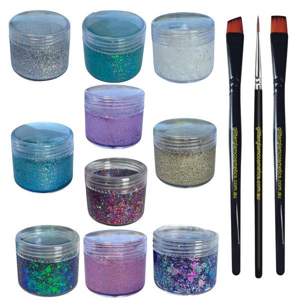 Assorted glitter jars with three application make up brushes on a white background