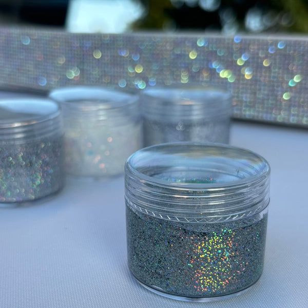 Silver glitter jar with a blurred glittery background