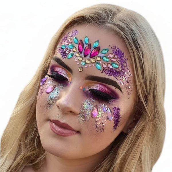 Woman with colorful face makeup featuring jewels and glitter on a white background