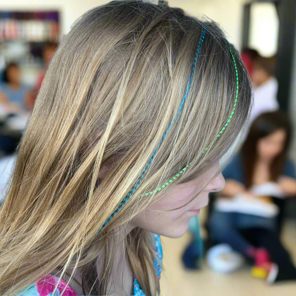 Person with colorful hair extensions in a salon setting