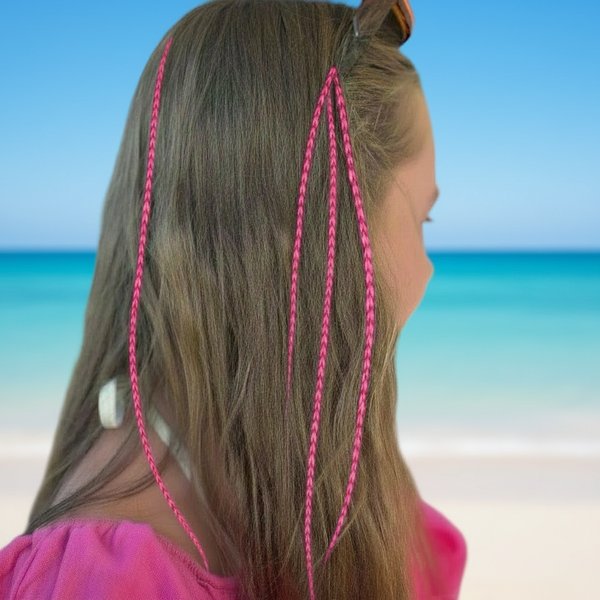Person with pink feathers against a beach background