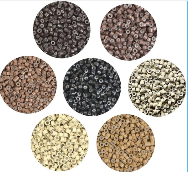 Collection of small round beads in various colours on a white background