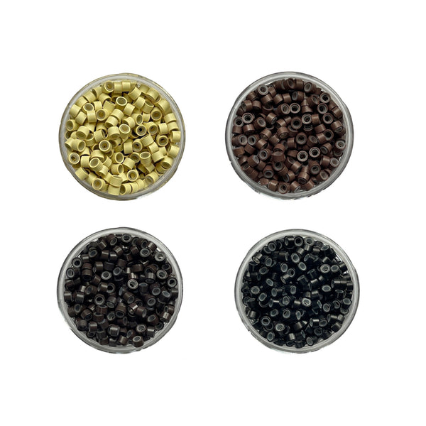 Four small round containers filled with different colored beads on a white background