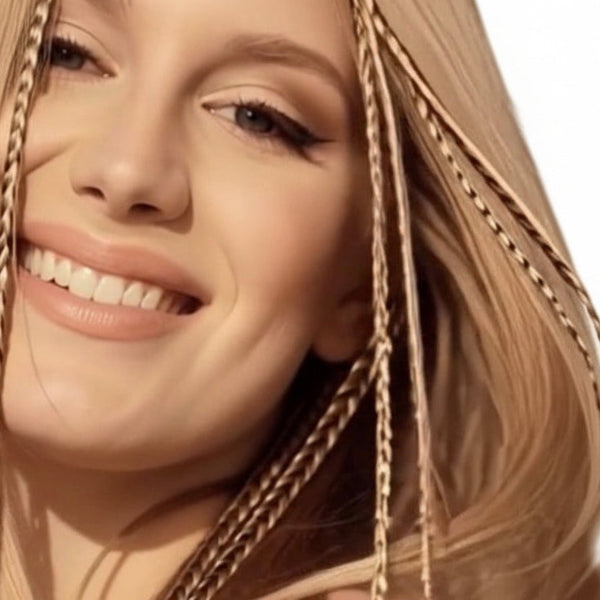 Close-up of a woman with blonde hair and a blue background