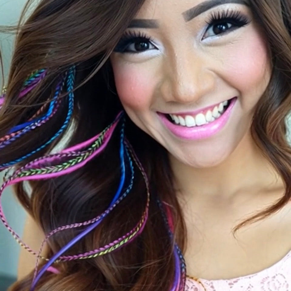 Woman with colorful hair extensions smiling