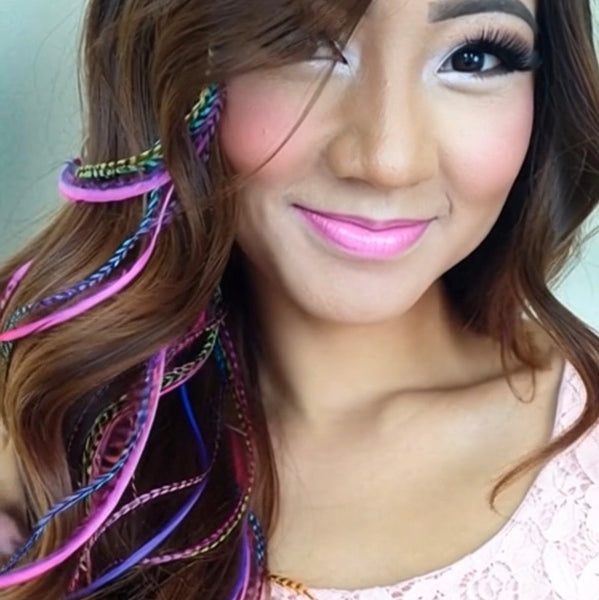 Woman with colorful hair extensions and pink lipstick