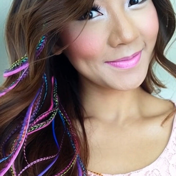 Woman with colorful hair extensions and pink lipstick