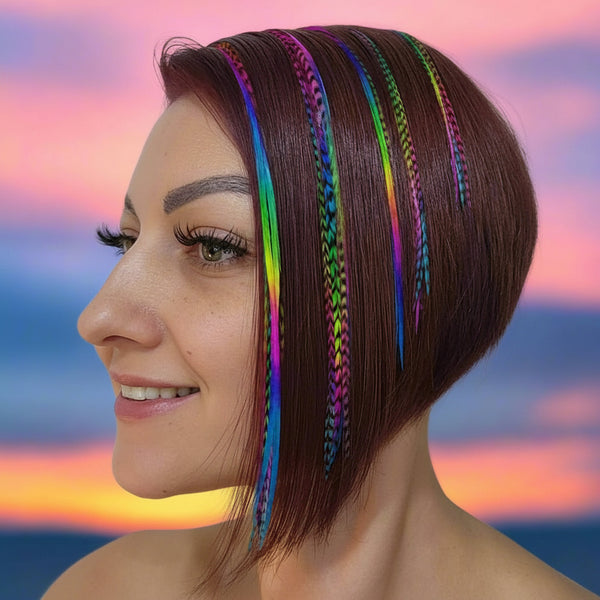 Woman with short brown hair featuring colorful rainbow feather hair extensions in solid and grizzly rainbow feathers against a white background