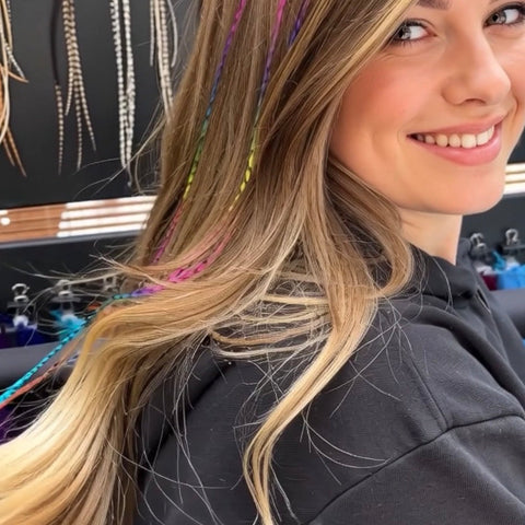 Woman with colorful hair extensions in a salon setting