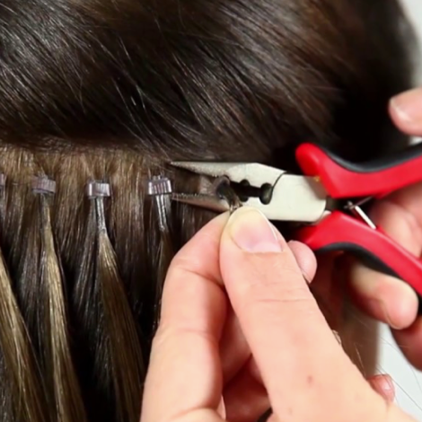 Person using scissors to remove bead attachments from hair extensions with text 'How to Remove Bead Attachments'.