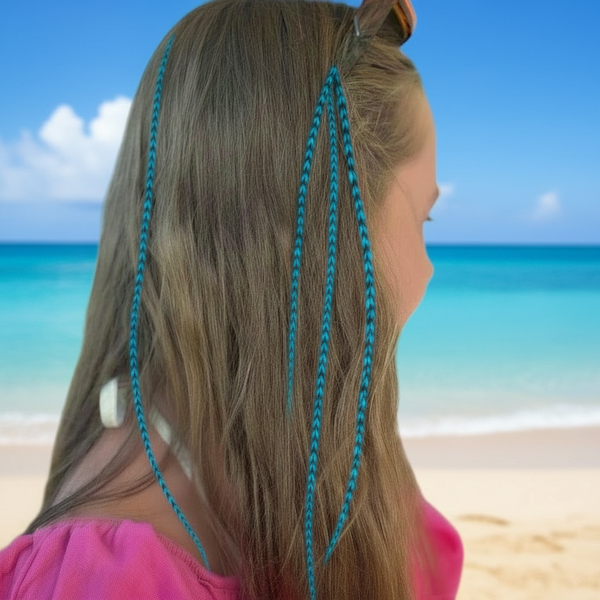 Woman with blue feathers looking at the ocean on a beach
