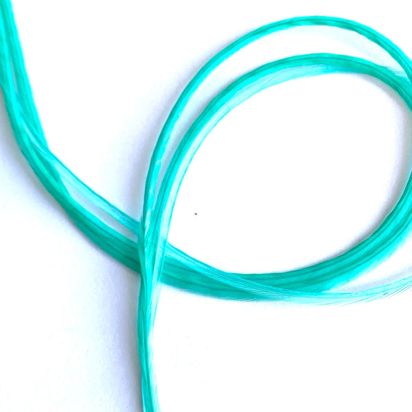 Aqua blue solid feather hair extensions on a white background