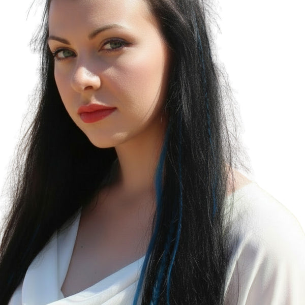 Woman with long dark hair , electric blue solid hair feathers and red lipstick against a white background