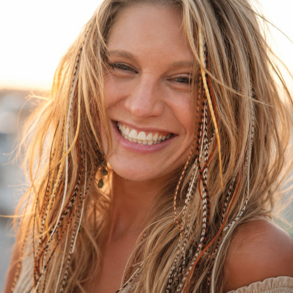 blonde haired woman wearing natural mix grizzly feather hair extensions