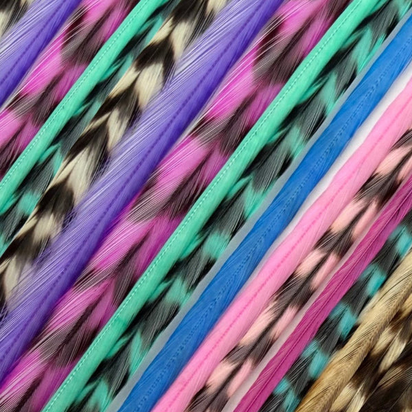 close-up coloured  grizzly feather hair extensions  in pinks, purples, blues and aqua, real grizzly pattern feather strands for hair styling
