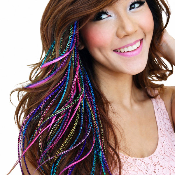 colourful grizzly feather hair extensions in pinks purple and blue long feather in brunette boho hairstyle by wild4feathers