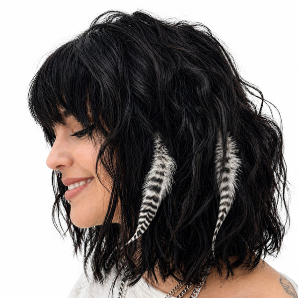 two natural fatz feather hair extensions in classic black and white grizzly striped fluffy feathers for hairstyling