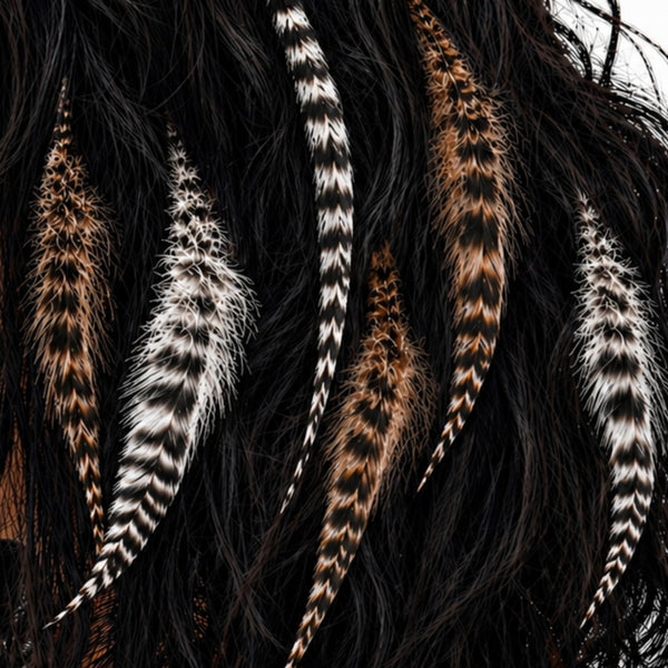 close up of natural brown grizzly, black and white grizzly fluffy feather hair extensions , wide'n'fluffy real striped feathers for hairstyling