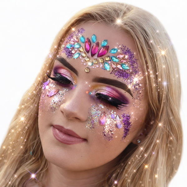 Woman with colorful face makeup featuring jewels and glitter 