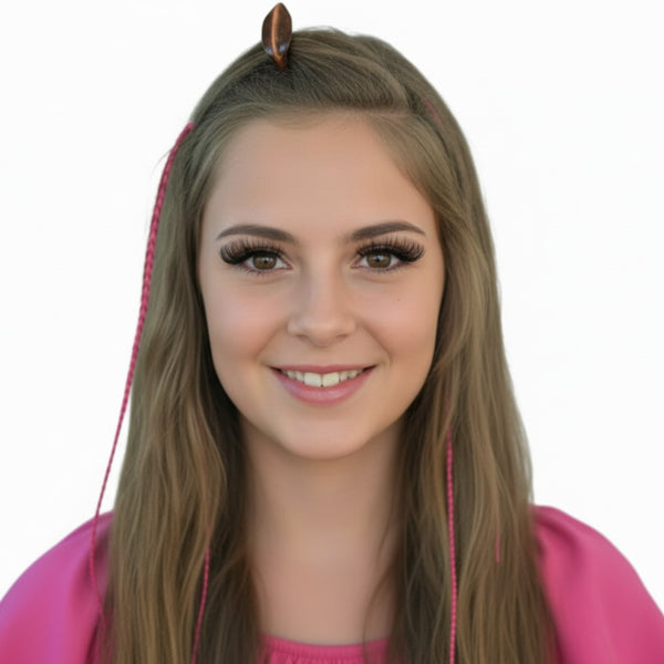 Person with pink hair extensions and a pink outfit on a white background