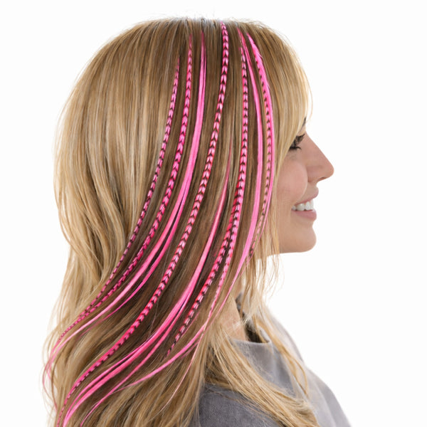 blonde haired woman wearing hot pink solid and grizzly mix feather hair extensions in long blonde hair