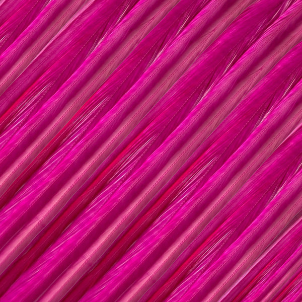 close up of pink magenta solid feather hair extensions in regular width ,real hair feathers for feather hairstyling