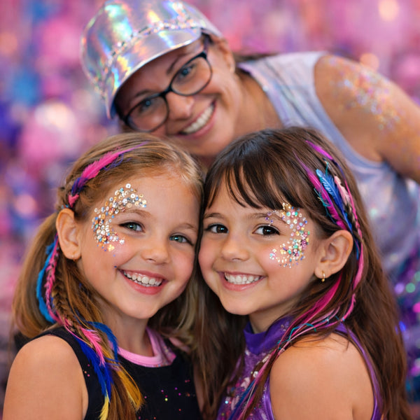 Two children glitterglam styled by Wild4Feathers staff with glittery face paint and colourful feather hair extensions birthday party celebration